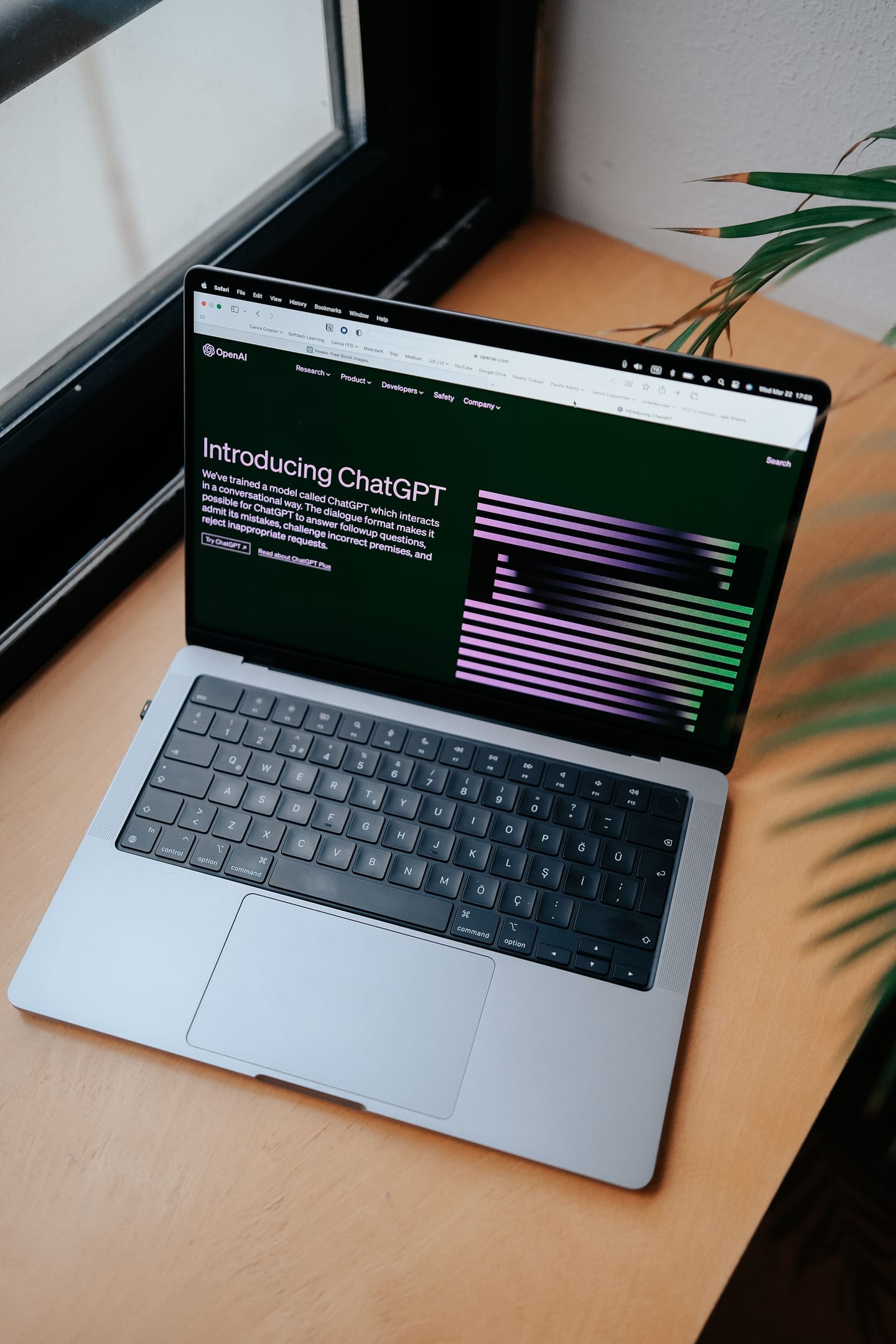 Laptop open on a desk showing an AI chatbot website